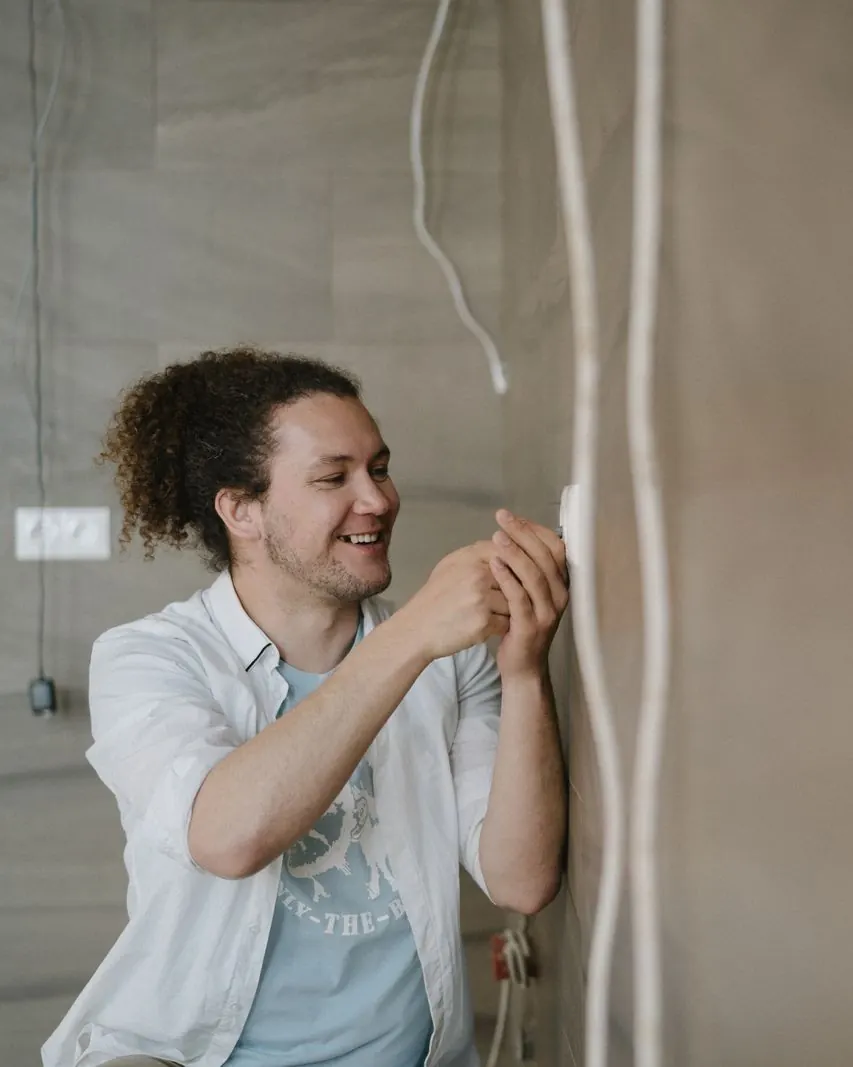 Smiling electrician on a site (illustration photo)